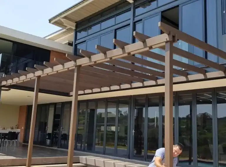 Modern composite pergola installed at a contemporary home, creating a stylish outdoor entertainment and patio area.